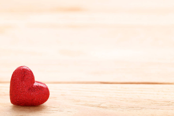 Red glitter heart on brown wooden table - Foto, Imagem