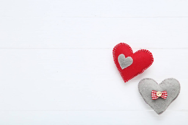 Fabric hearts on white wooden table - 写真・画像