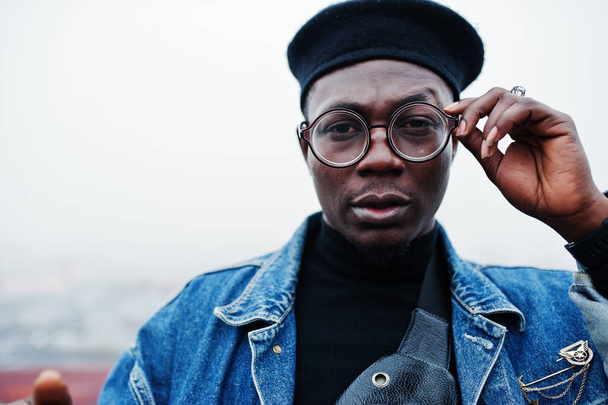 Close up portrait of african american man in jeans jacket, beret and eyeglasses. - Фото, зображення
