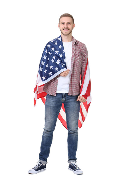 Young man holding an American flag on white background - Fotoğraf, Görsel