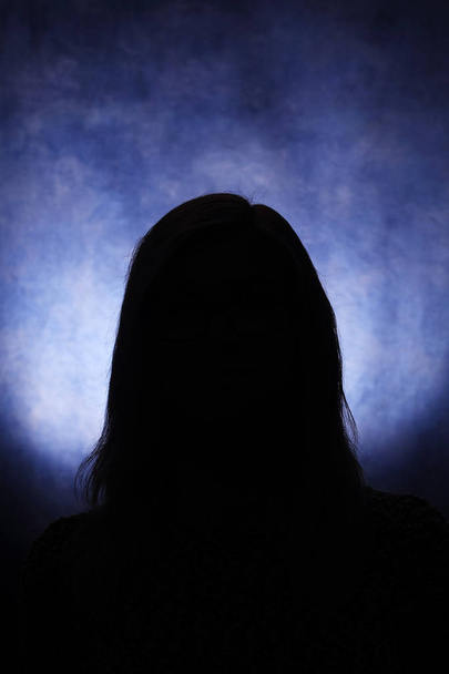Silhouettes of a female head on a blue background - Foto, Imagem