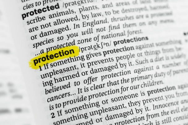 Highlighted English word "protection" and its definition at the dictionary. - Zdjęcie, obraz