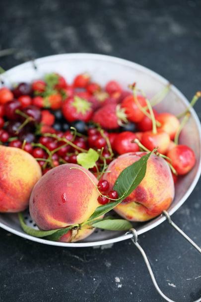 garden organic berries and fruits on a sieve - Foto, Bild