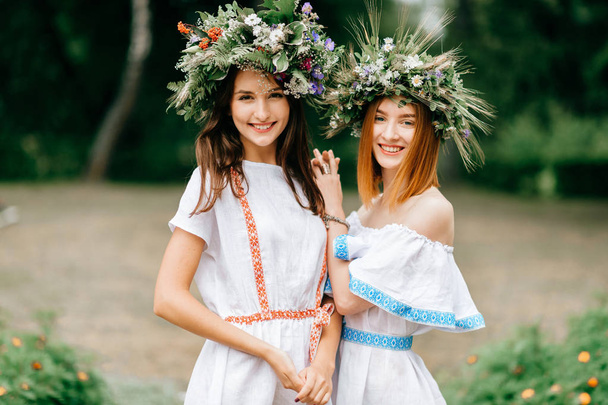 portrait of beautiful women in ethnic clothes and wreathes  - Fotografie, Obrázek