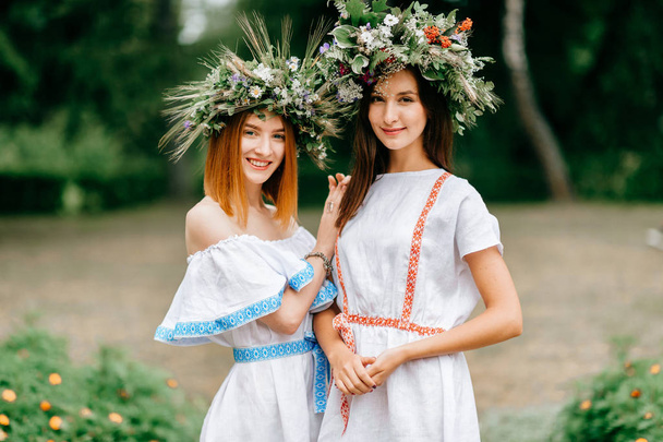 portrait of beautiful women in ethnic clothes and wreathes  - Foto, immagini