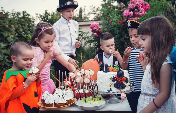 A festive table with sweets. Children celebrate Halloween - Photo, Image