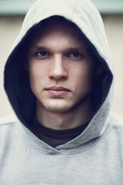 A handsome young man in a gray hood - Photo, Image