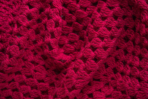 Soft folds of a warm red knitted woolen poncho to be used as background - Photo, Image