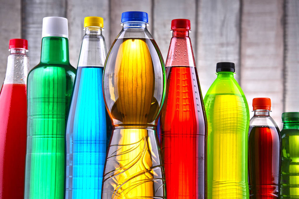 Plastic bottles of assorted carbonated soft drinks in variety of colors. - Photo, Image