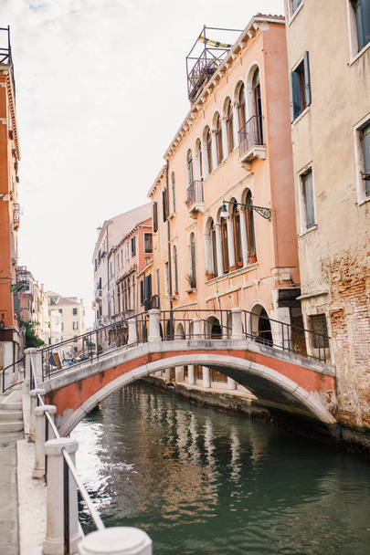 view of the canal and old houses in the beautiful city of Venice in Italy - 写真・画像