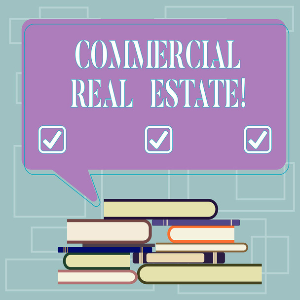 Text sign showing Commercial Real Estate. Conceptual photo property that is used solely for business purposes Uneven Pile of Hardbound Books and Blank Rectangular Color Speech Bubble. - Zdjęcie, obraz