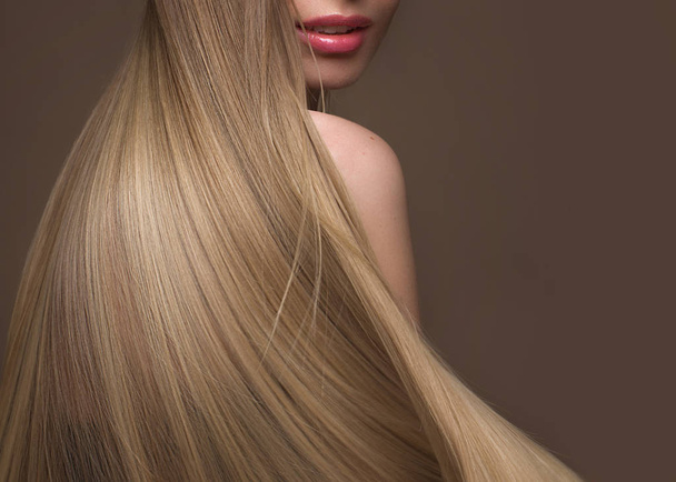 Beautiful blond girl with a perfectly smooth hair, classic make-up. Beauty face - Фото, изображение