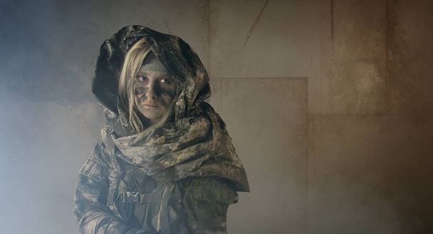 hunter woman in camouflage posing in dark building indoors - Фото, изображение