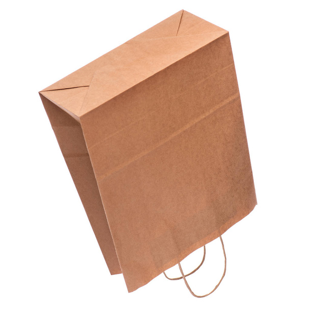 Een lege bruine papieren zak. Kringlooppapier boodschappentas geïsoleerd op witte achtergrond. - Foto, afbeelding