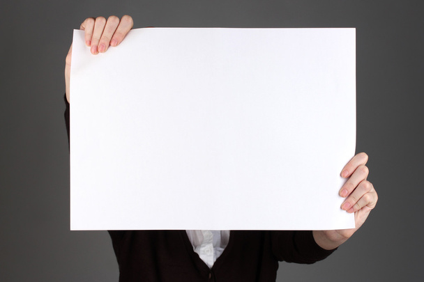 Woman holding blank sign in front her face, on color background - Foto, immagini