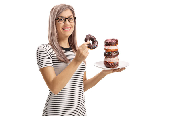 Young woman holding a chocolate donut isolated against white background - Foto, Imagen