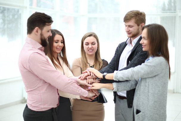 portrait of confident business team stacking hands - Foto, Bild