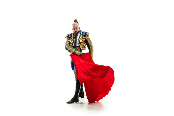 Torero in blue and gold suit or typical spanish bullfighter isolated over white - Valokuva, kuva
