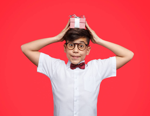 Adorable boy with present on head - Photo, image