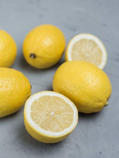 Lemons on grey stone background, top view, copy space. Organic fresh citrus fruits - Foto, afbeelding
