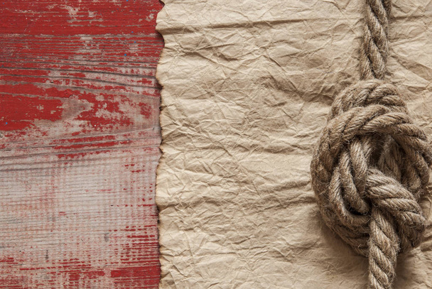 Fundo náutico com papel velho ou pergaminho ou mapa e uma corda com um nó de marinheiro
 - Foto, Imagem