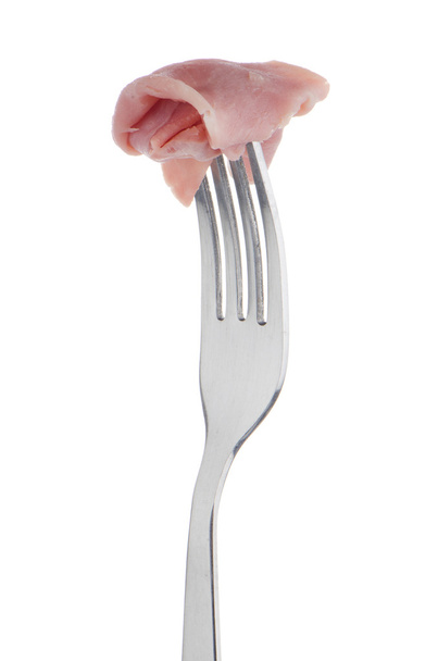Slice of ham skewered on a fork - Foto, imagen