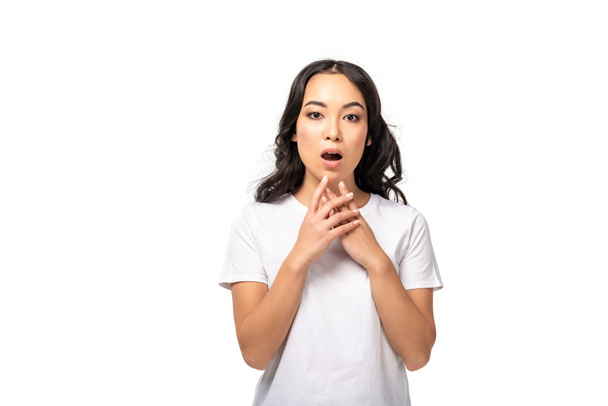 worried asian woman in white t-shirt holding hands near face isolated on white  - Photo, Image