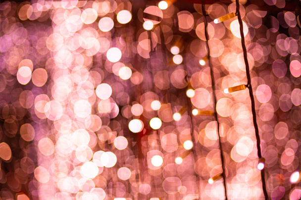 Pink bokeh blurred lights background. Rose garlands decoration for the new year festival celebration. - Photo, Image