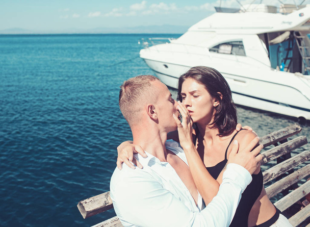 Sexy woman and man at sea bay. Family and valentines day. Love relations of kissing couple enjoying summer day. Summer holidays and travel vacation. Couple in love relax at yacht for marine travel - Фото, зображення