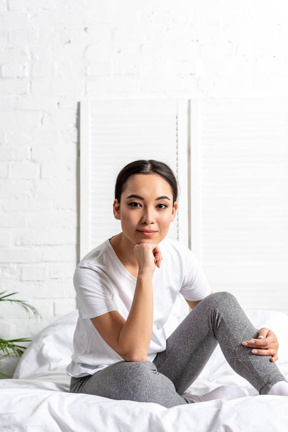 young asian woman sitting in bed in morning - Photo, Image