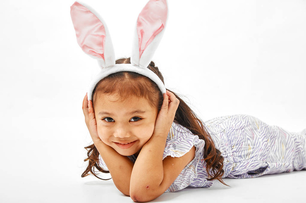 Portrait of a happy little girl with bunny on a white background - Zdjęcie, obraz
