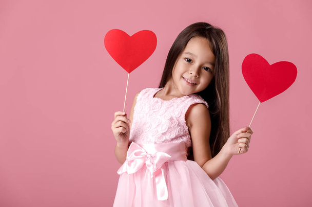 cute little girl in a pink dress holding a paper heart - Foto, Imagen