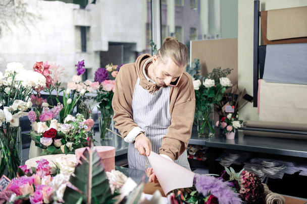 Pleased blonde florist taking his finished bouquet - Fotoğraf, Görsel