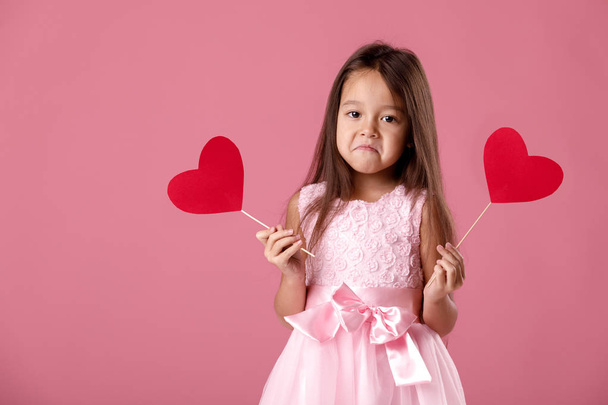 cute little girl in a pink dress holding a paper heart - Photo, Image