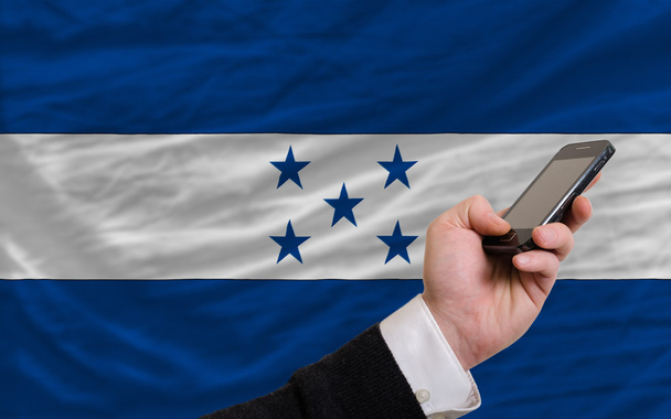 ホンジュラスの国旗はフロントでの携帯電話 - 写真・画像