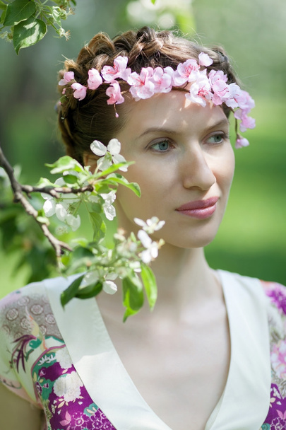 The young woman in spring garden - Zdjęcie, obraz