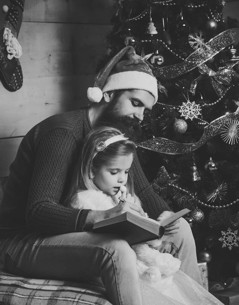Santa claus kid and bearded man at Christmas tree. - Фото, зображення