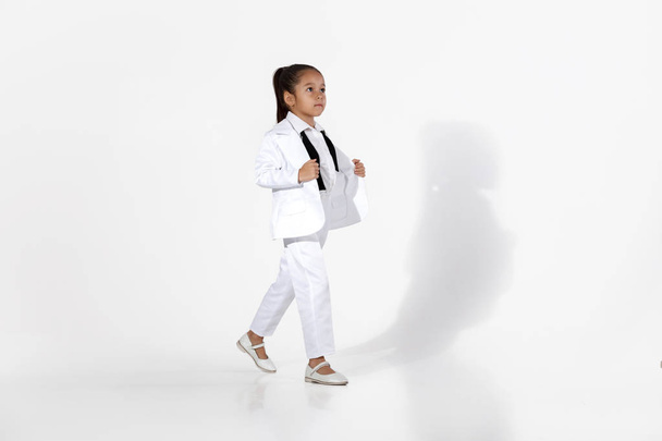 fashion little girl model in a white suit and bow tie - Фото, изображение