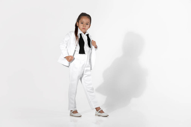fashion little girl model in a white suit and bow tie - Foto, Imagen