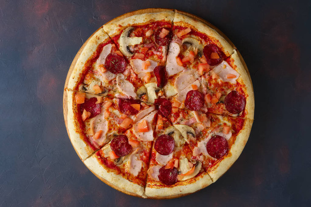 Top view of pizza with champignon, ham and sausage - Fotografie, Obrázek