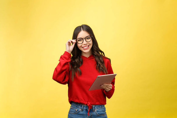 Picture of happy teenage girl with tablet pc computer isolate on yellow background - Φωτογραφία, εικόνα