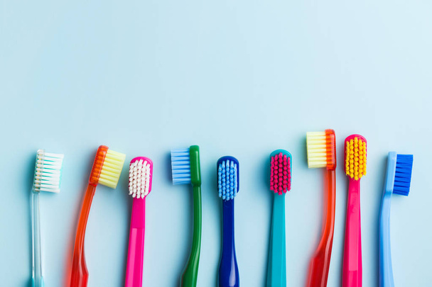 Colorful toothbrushes on blue background. Top view. - Foto, Bild