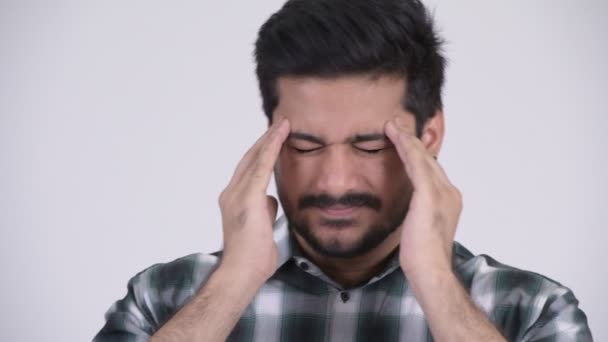 Young stressed bearded Indian man having headache - Πλάνα, βίντεο