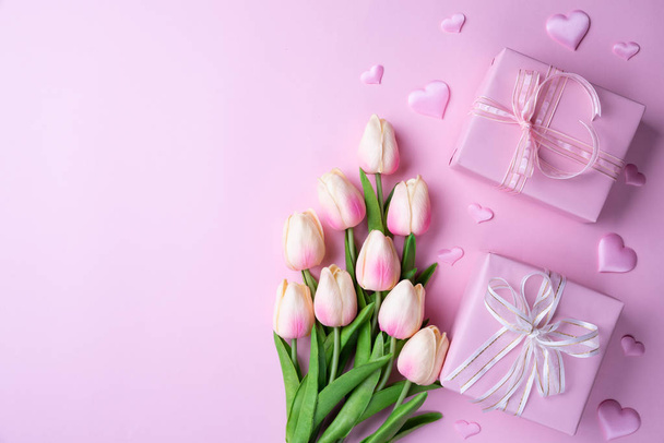 Valentines day and love concept. Pink tulips, gift box with heart on pink background. - Fotografie, Obrázek