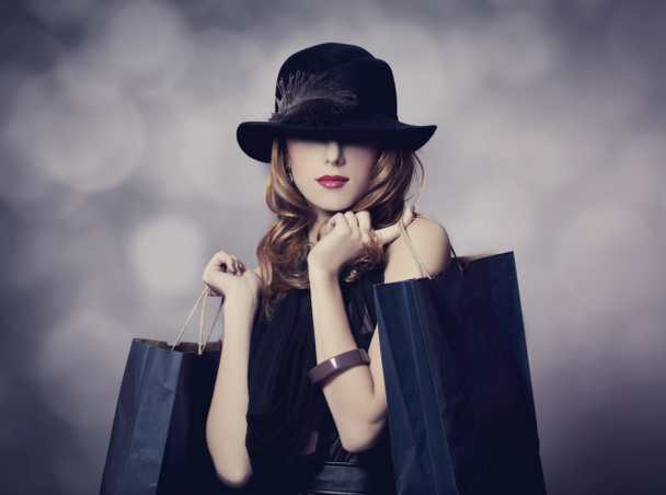 Style redhead girl with shopping bags. - Photo, Image