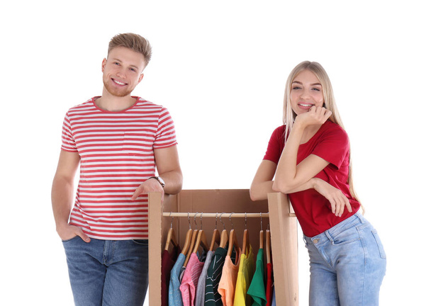 Young couple near wardrobe box on white background - Foto, afbeelding
