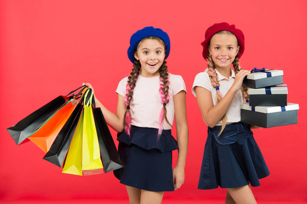 Best price. Buy now. Visit shopping mall. Kids girls hold bunch shopping bags or birthday gifts packages. Dreams come true. Happy childhood. Shopping concept. Child cute small girls on shopping tour - Zdjęcie, obraz