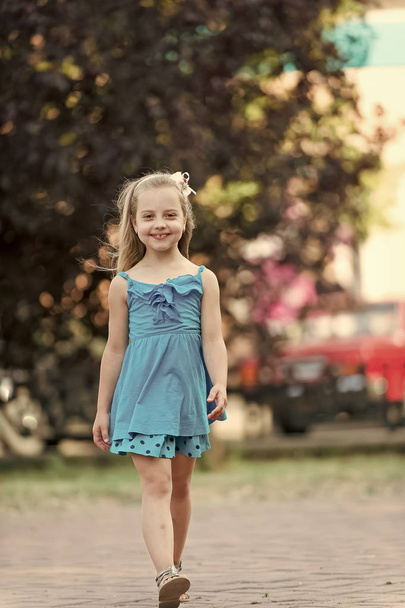 small baby girl with smiling face in blue dress outdoor - 写真・画像