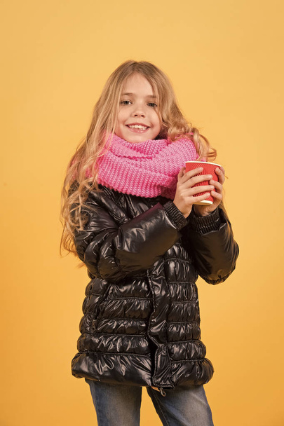 Girl with long blond hair in black jacket hold mug - Foto, afbeelding