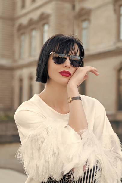 Woman in sunglasses posing on building in Paris, France - Fotó, kép